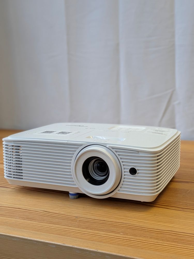 Optoma 5000 lumen Full HD projector rental unit for bright event spaces, displayed on a wooden surface