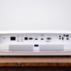 4K UHD projector rental rear input panel with HDBaseT, dual HDMI, VGA, and USB ports on a wooden surface
