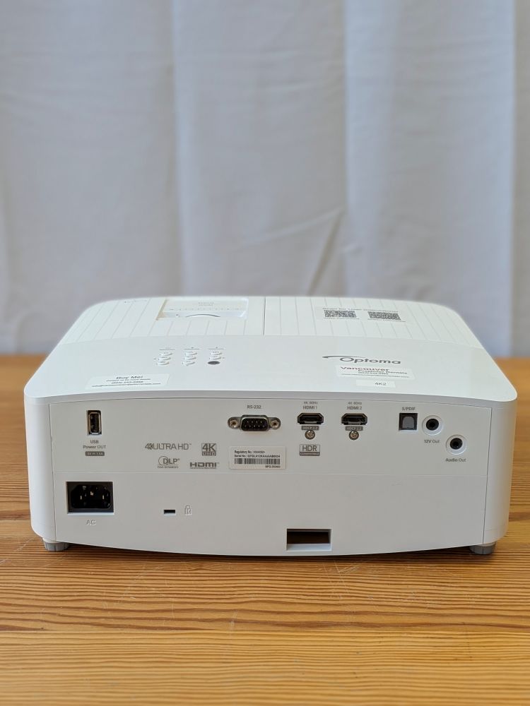 Back of a white Optoma 4K projector rental with HDMI, HDR, S/PDIF, and audio output ports visible