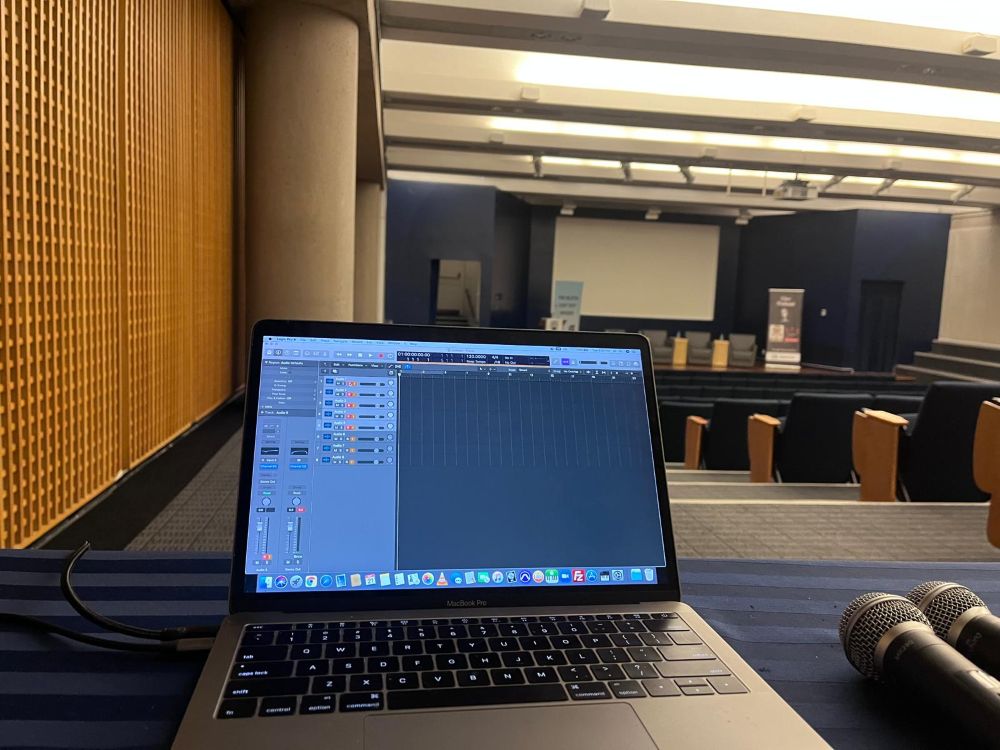 laptop rental for podcast recording Laptop on table with two microphones