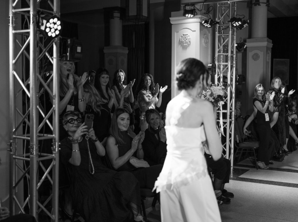 LED stage lights mounted on aluminum truss rigs illuminating a fashion show runway and audience area