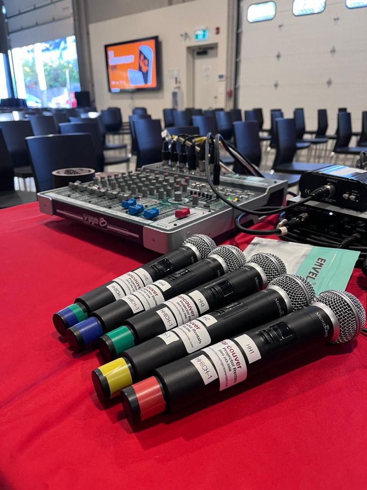 Four microphones on a red table