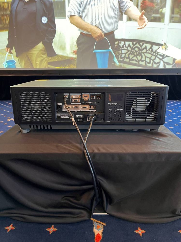Panasonic laser projector rental with visible input ports and power cables set up at an indoor Vancouver event