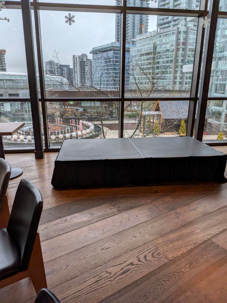 Event stage rental on a wood floor in a Vancouver high-rise venue