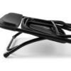Angled close-up of a black folding chair in its folded position showing the metal frame and plastic seat and back