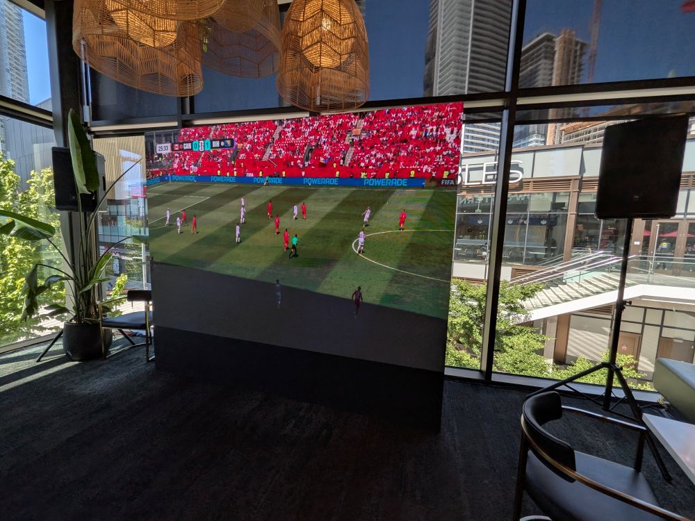 Indoor LED wall rental showing a FIFA World Cup corner kick moment at a packed Vancouver restaurant watch party