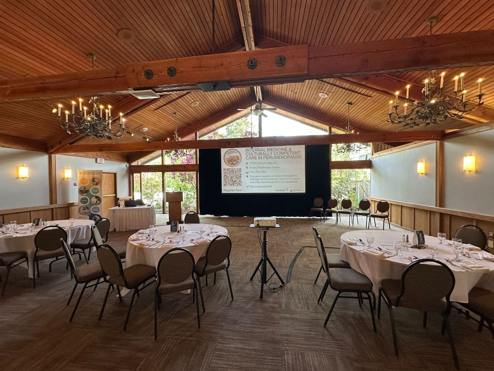 Fast-fold projection screen and projector rental on a tripod stand set up in the rustic banquet hall at Hazelmere Golf Course in Surrey