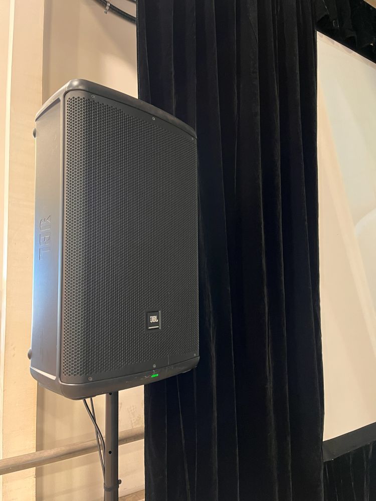 Black JBL professional PA speaker rental on a pole stand set up for a FIFA World Cup watch party in Maple Ridge