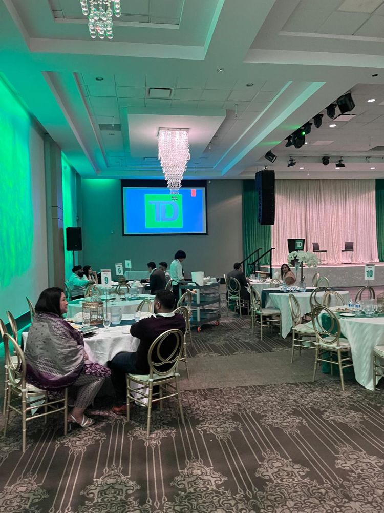 TD Bank branded projection screen rental in an elegant ballroom with green ambient lighting