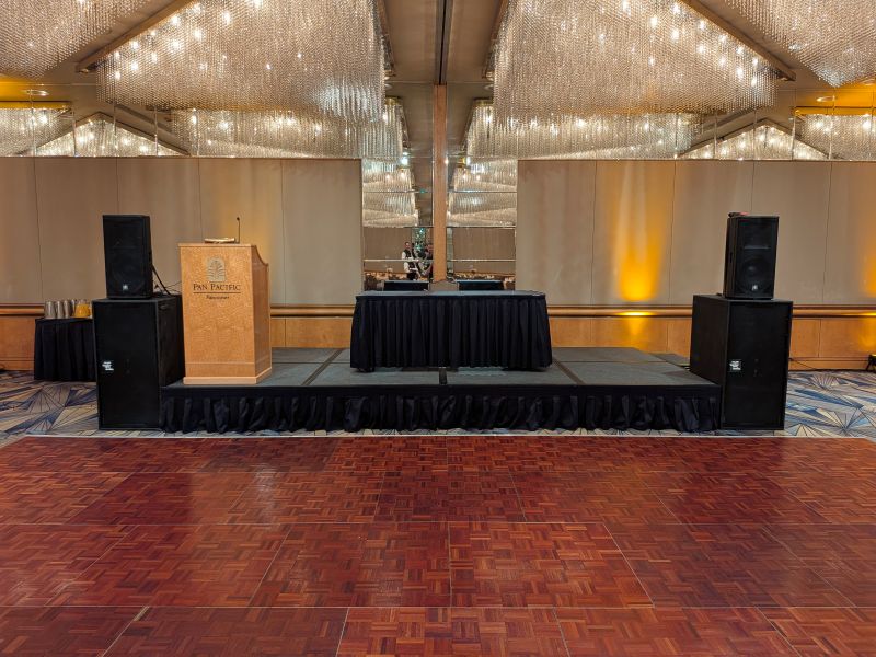 Dual fast-fold projector screens flanking the stage and DJ booth at a prom in the Pan Pacific Hotel Vancouver ballroom