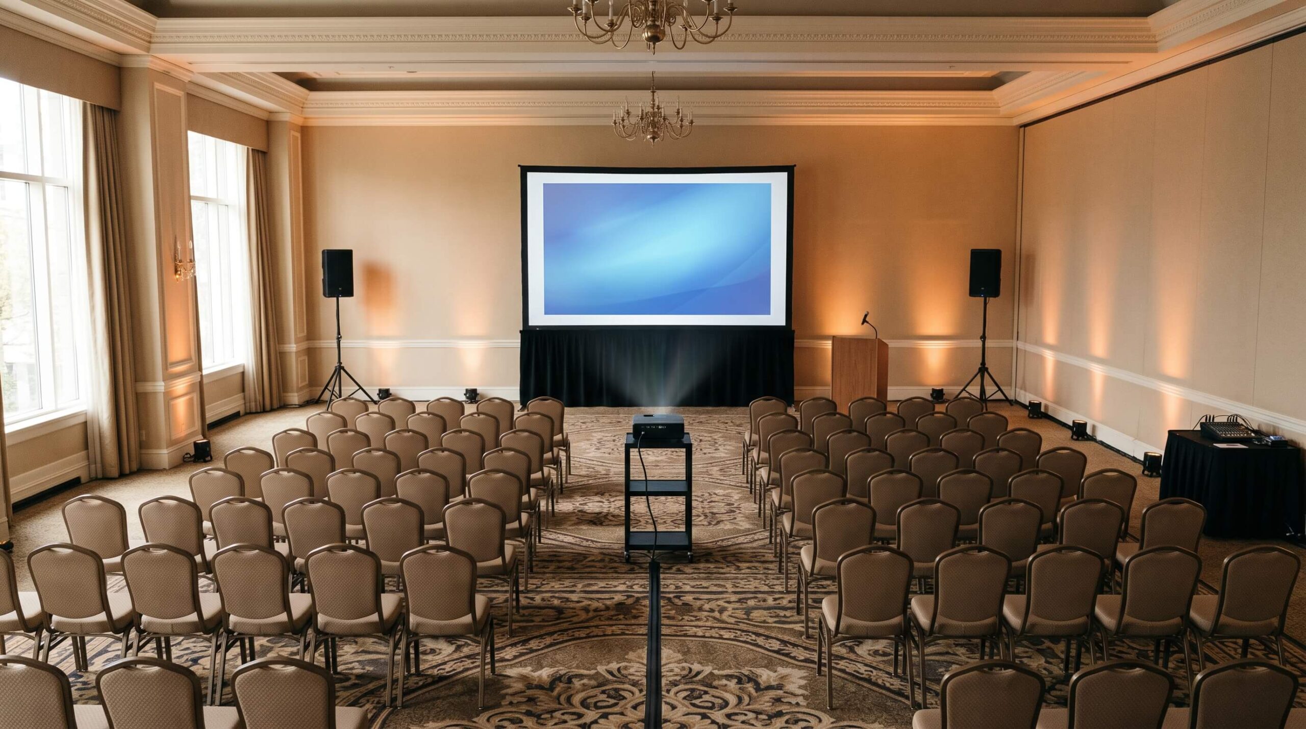 podium with a gooseneck mic in front of a large FastFold screen at a conference